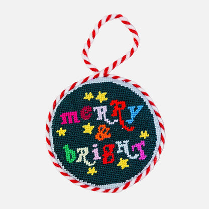 Round embroidered ornament with 'Merry & Bright' text on a white background