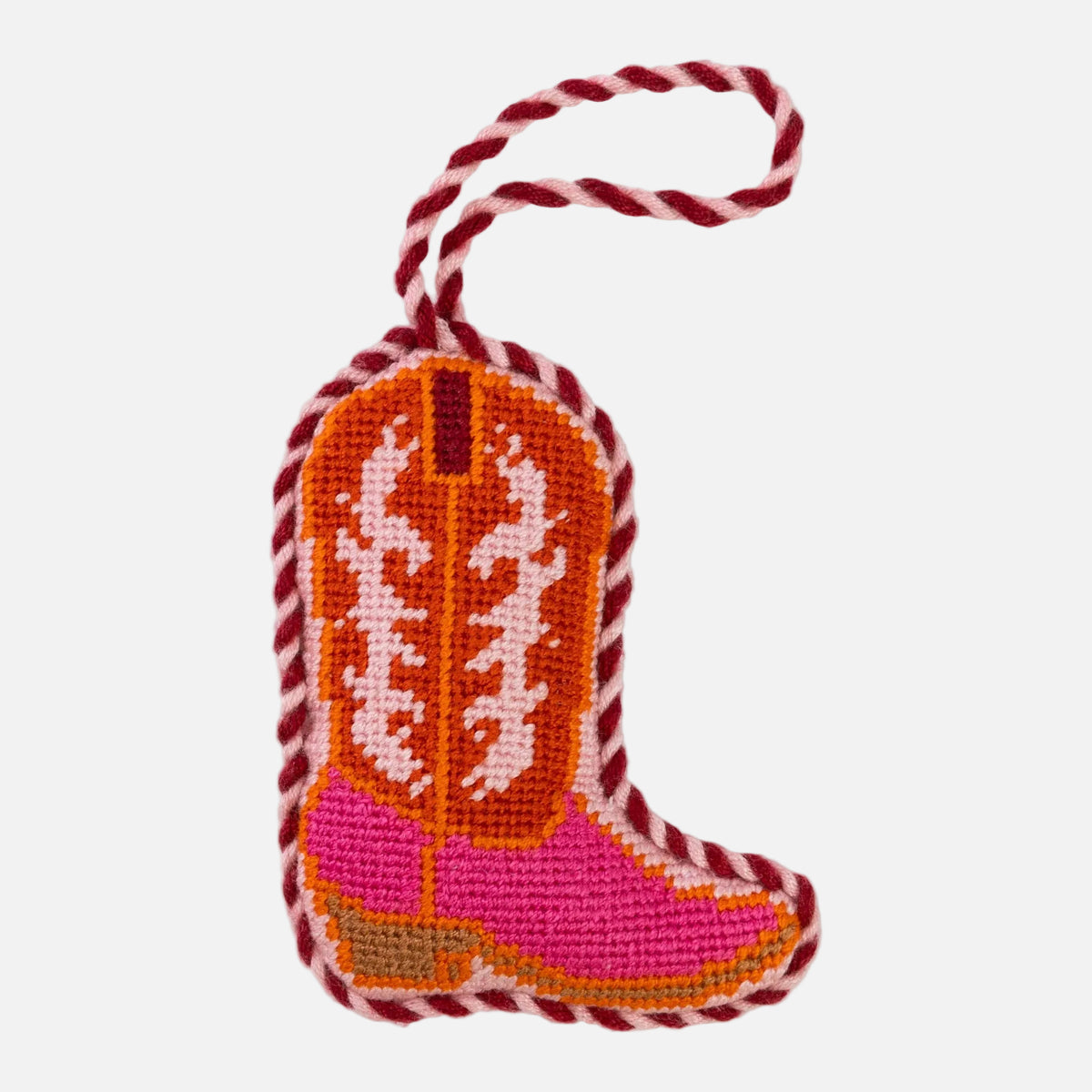 Pink cowboy boot ornament with orange and white pattern on a white background