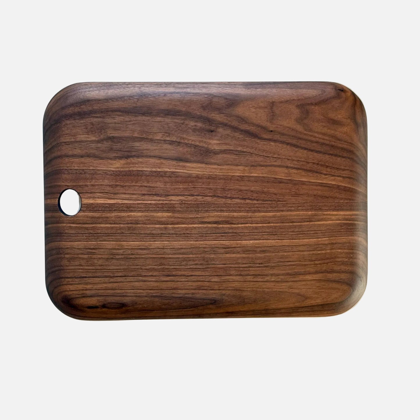 Wooden cutting board with a hole on a marble surface