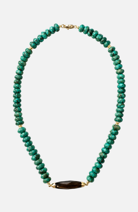 Green beaded necklace with a dark green stone on a white background