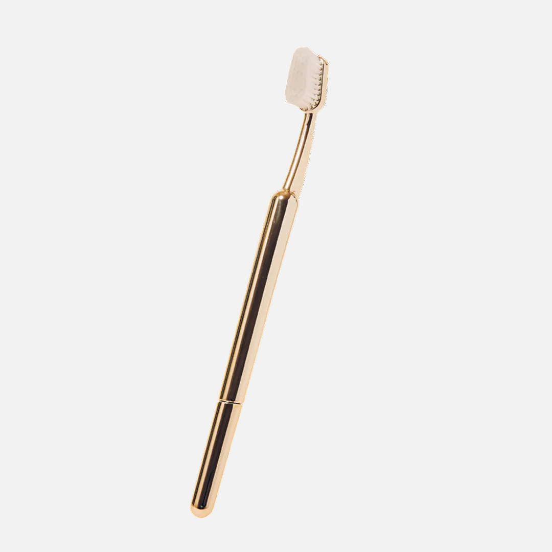 Gold-colored dental tool on a white background