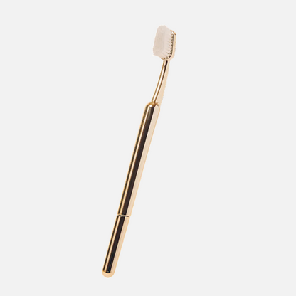 Gold-colored dental tool on a white background