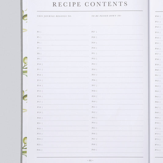 An open recipe journal or planner showing printed recipe contents pages with lined fields and decorative green leaf illustrations along the left margin, photographed on a light gray background.