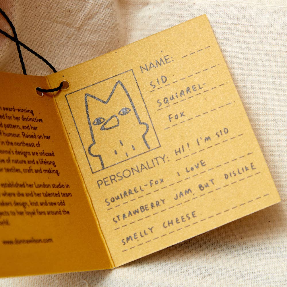 Card with a drawing of a squirrel and text about a character named Sid on a beige background