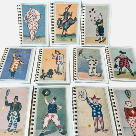 Set of vintage-style playing cards with colorful illustrations of clowns and other characters on a neutral background.