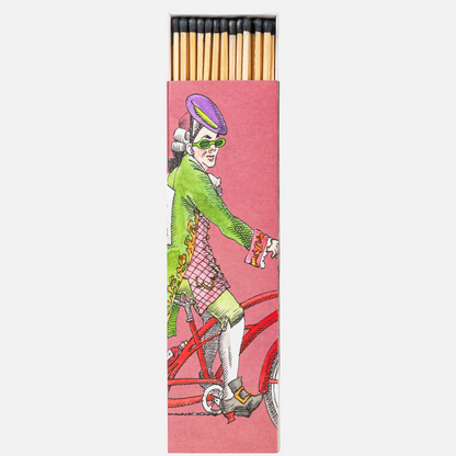 scented matches in a pink box with figure on a bike that is slightly open