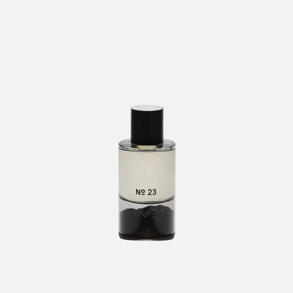 Clear bottle with black cap and black substance labeled 'No 23' on a white background