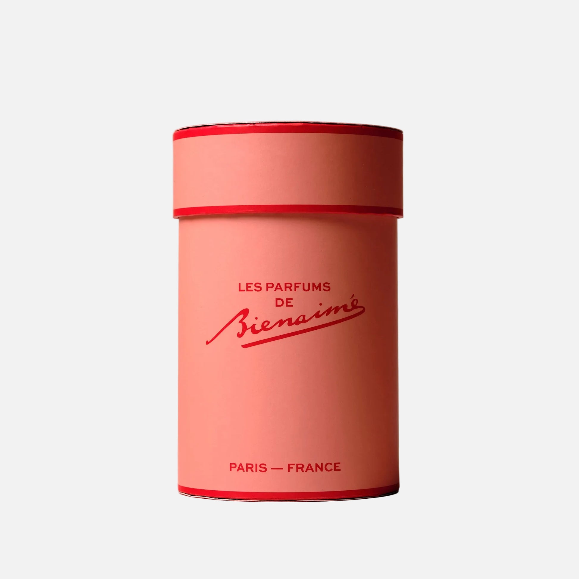 Pink cylindrical container with red lid featuring 'Les Parfums de Bienaimé' branding on a light gray background.