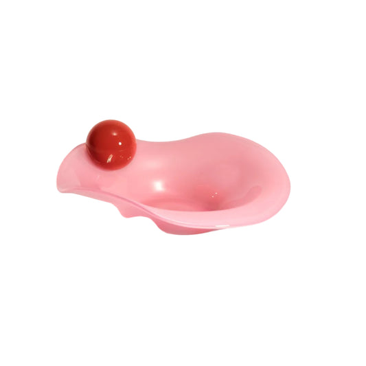 Pink bowl with a red ball on the rim