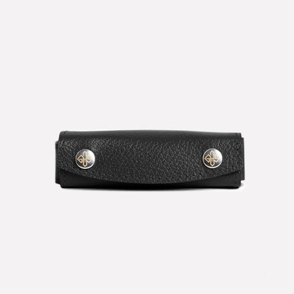Black leather case with gold accents on a white background