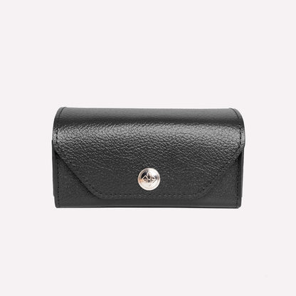 Black leather wallet with a gold button on a white background