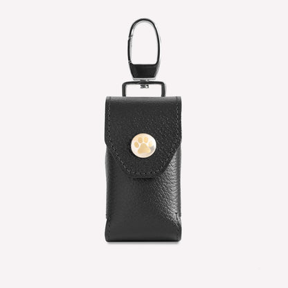 Black leather keychain pouch with a gold button on a white background