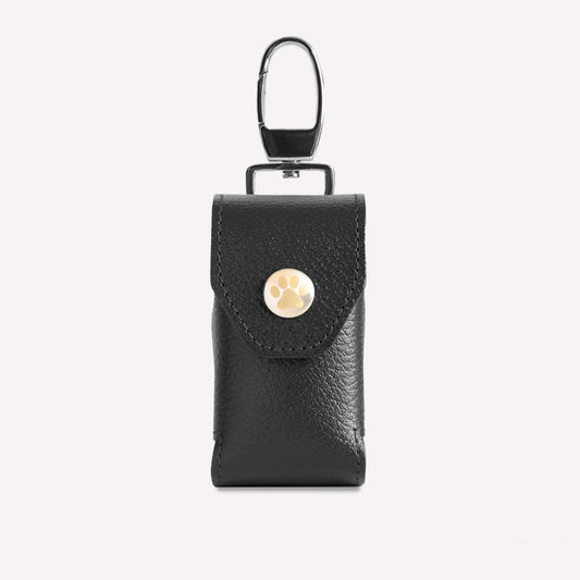 Black leather keychain pouch with a gold button on a white background