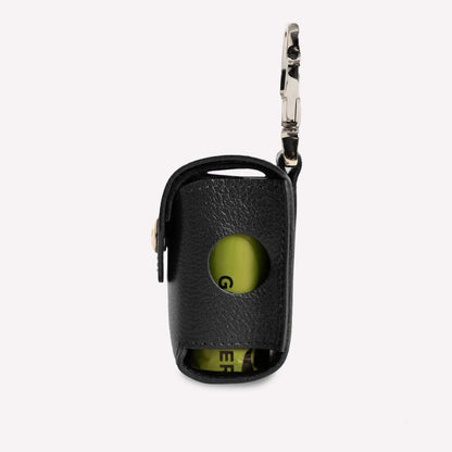 Black key fob cover with a green button on a white background