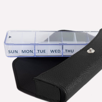 Weekly pill organizer with black carrying case on a white background