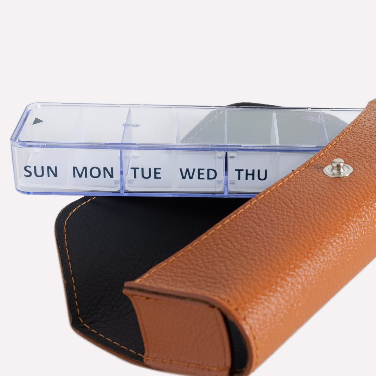 Brown leather case with clear plastic weekly planner insert on a white background