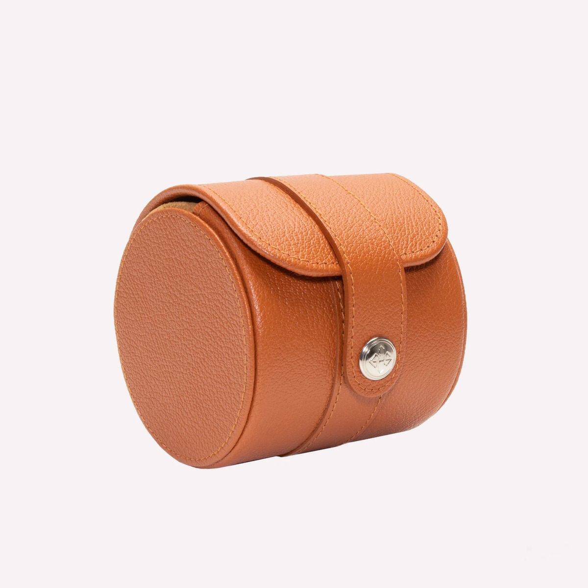 Round brown leather case with a silver button on a white background