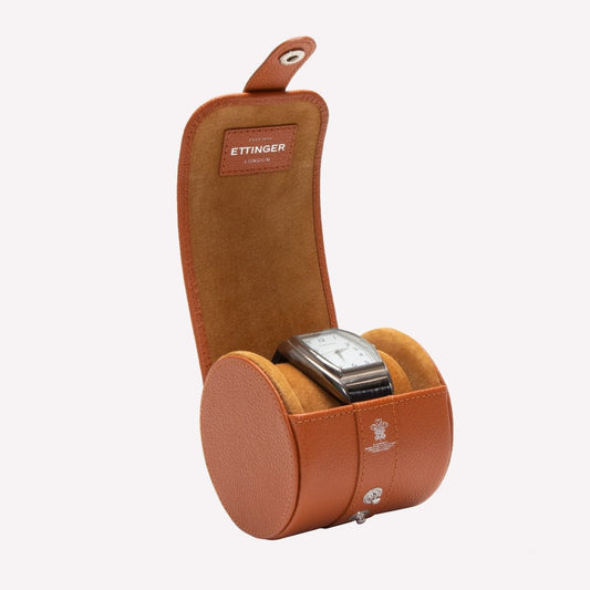 Brown watch case with a watch inside on a white background, featuring the Ettinger brand.