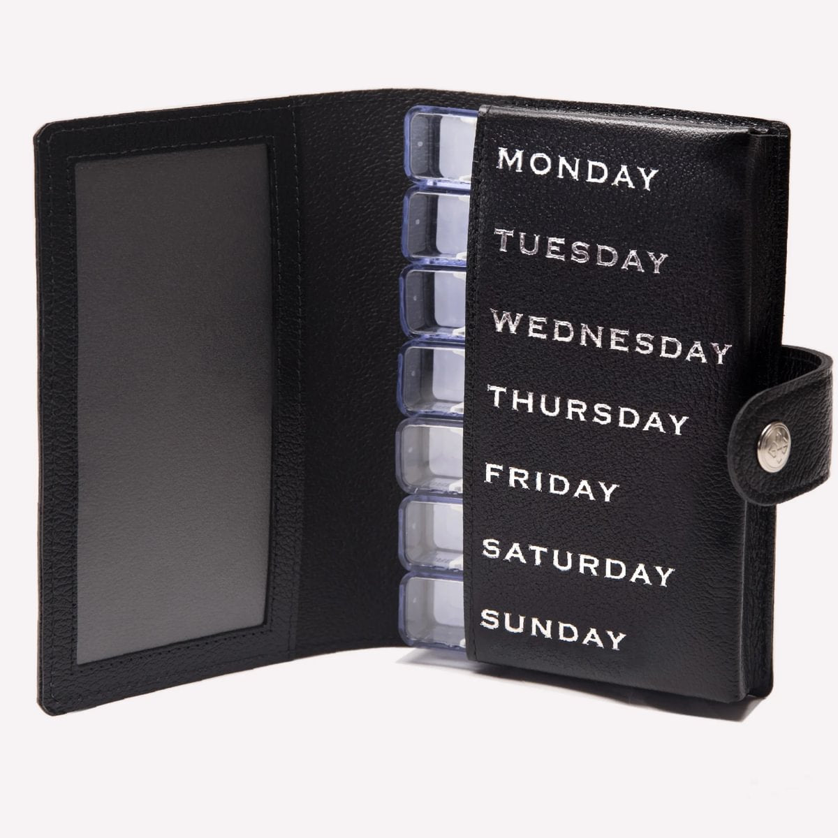 Black pill organizer with days of the week labels on a white background