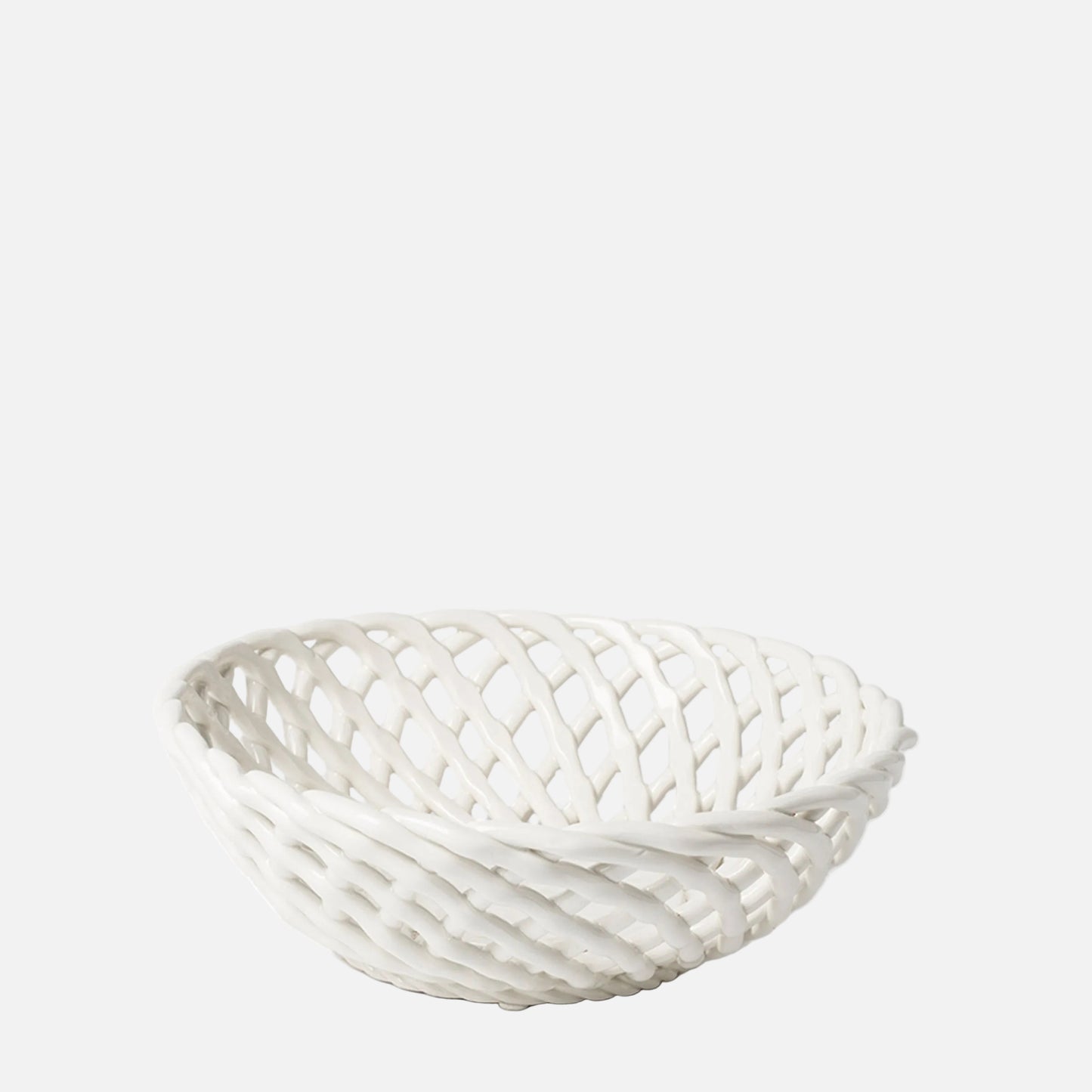 A white woven basket with an open lattice design, photographed on a seamless white background.