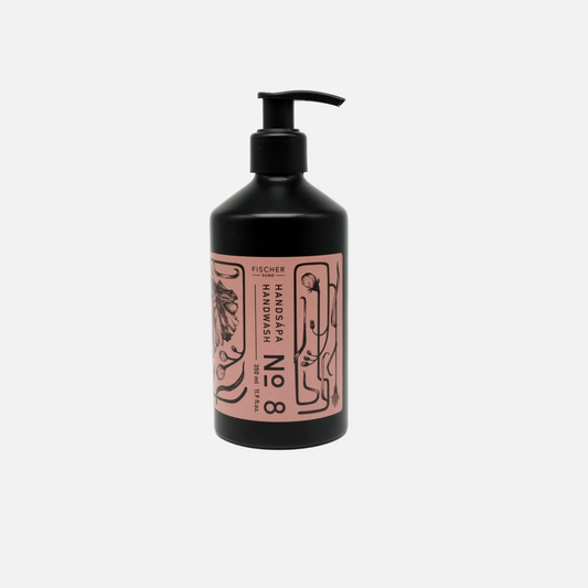 Black hand soap bottle with pink label on a white background