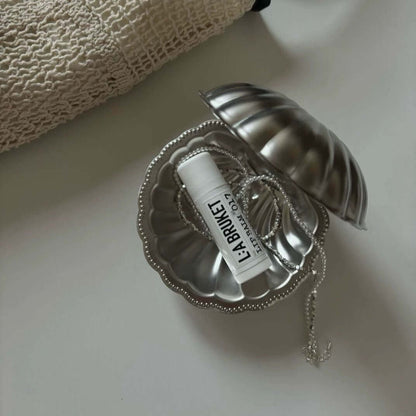 Vintage Metal Shell Box, open, holding a folded card