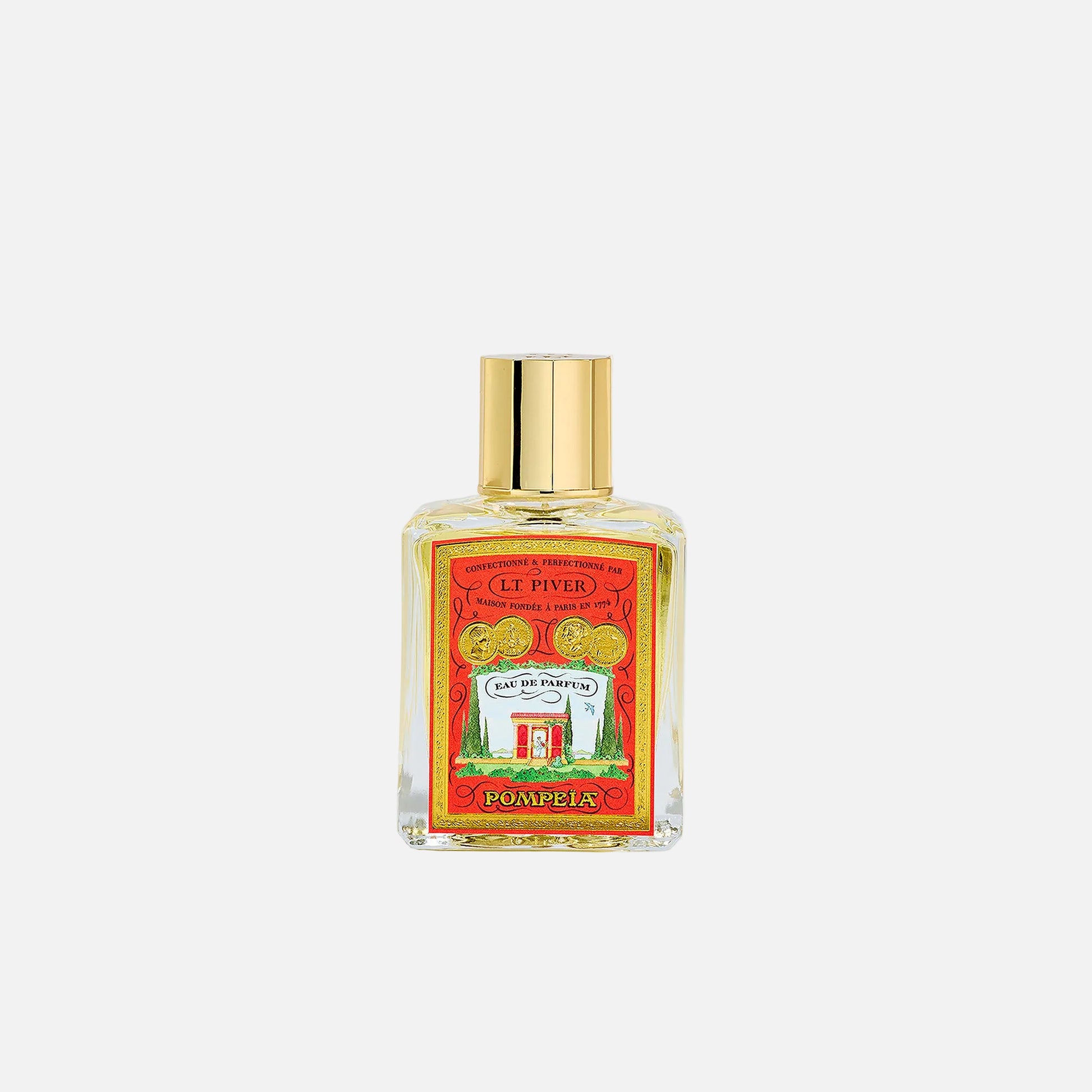 Perfume bottle with a gold cap on a light gray background