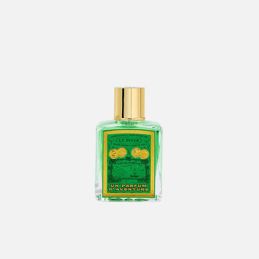 Perfume bottle with green label and gold cap on light gray background