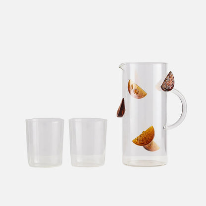 Glass pitcher with leaf design on a white background