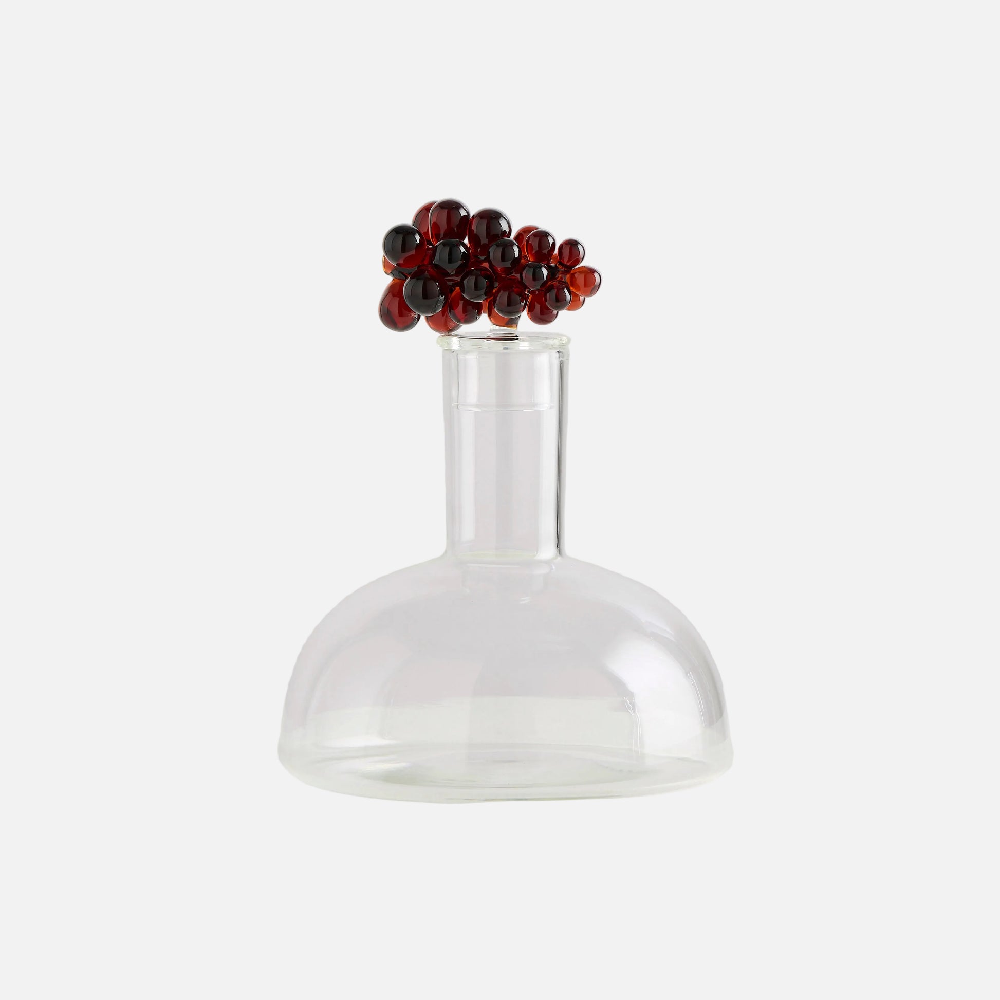 Clear glass vase with a decorative red and black bead top on a white background