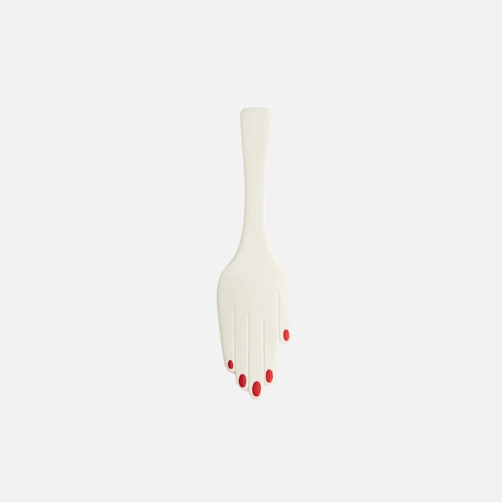 White plastic fork with red accents on a light gray background