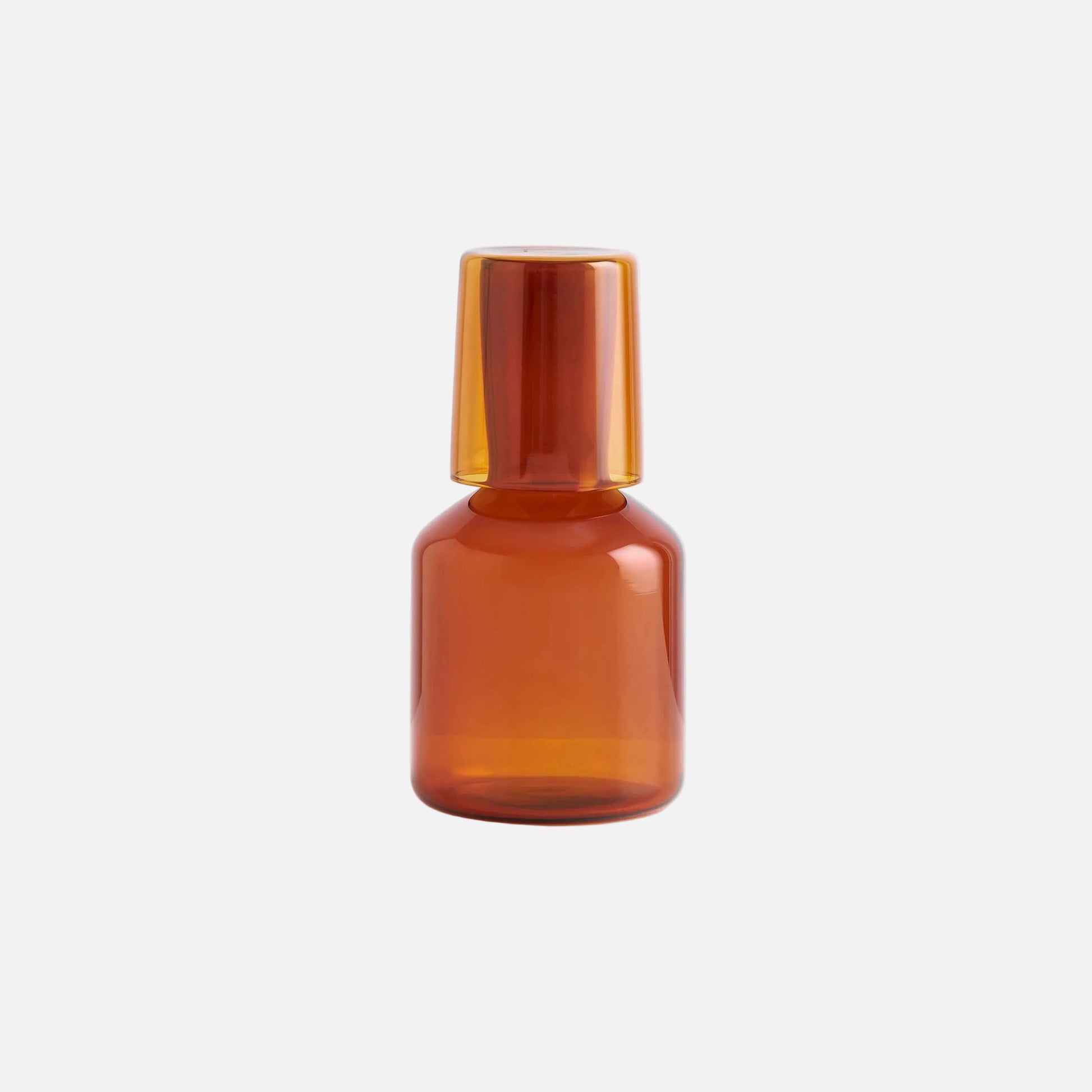 Amber glass bottle on a light gray background
