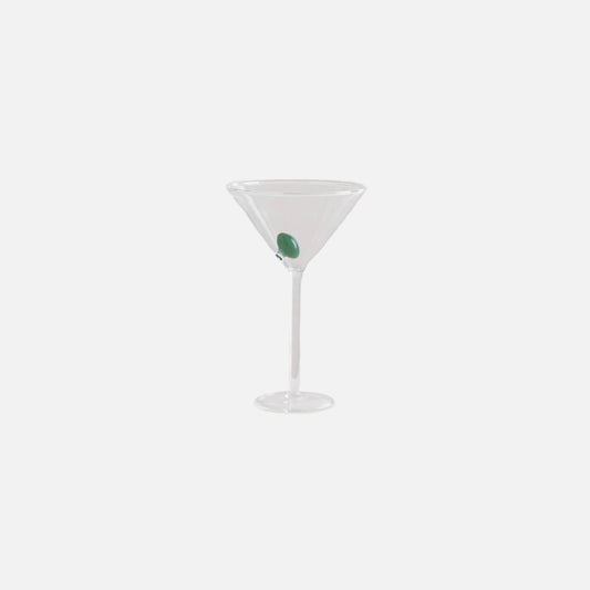Clear martini glass with a green olive on a white background