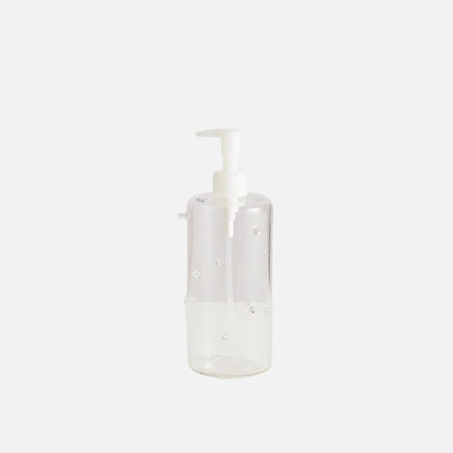 Clear bottle with white pump on a light gray background