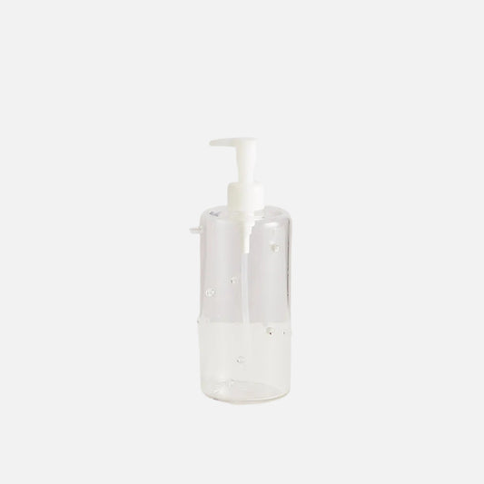 Clear bottle with white pump on a light gray background