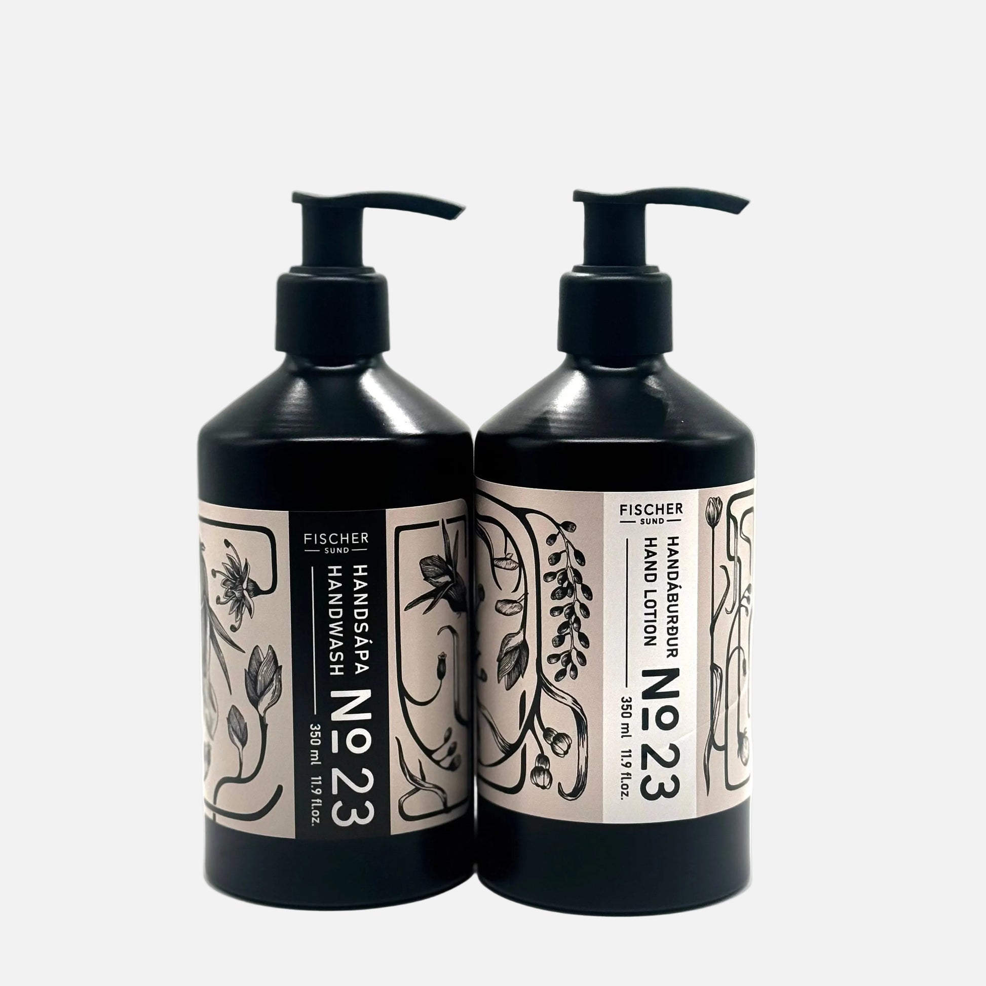 Two black bottles of Fischer Handzeugurum No 23 hand wash and lotion on a white background