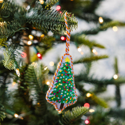Decorative Christmas tree ornament hanging on a lit Christmas tree
