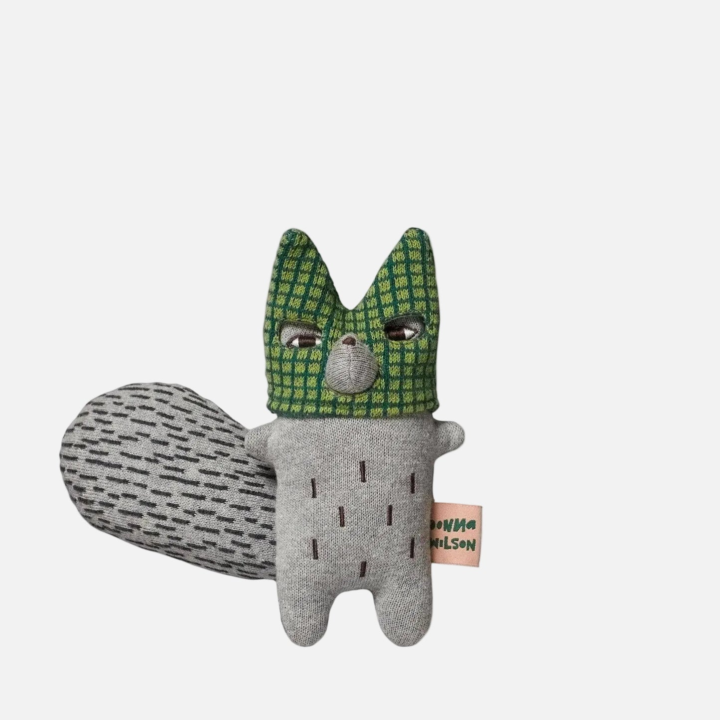Plush toy fox with green checkered hood on a white background
