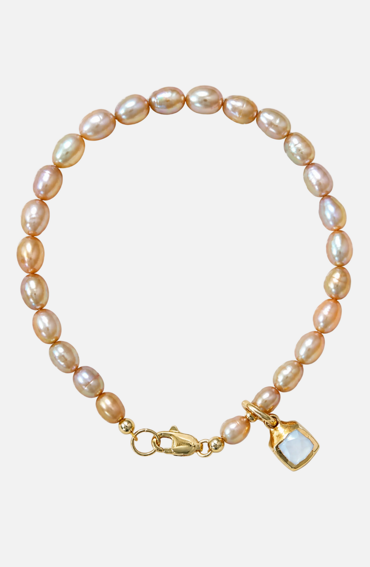 Pearl bracelet with a gold clasp and a heart-shaped charm on a white background