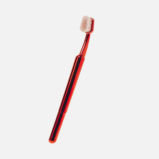 Red toothbrush on a white background