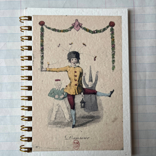 Notebook with vintage-style illustration on a tiled surface