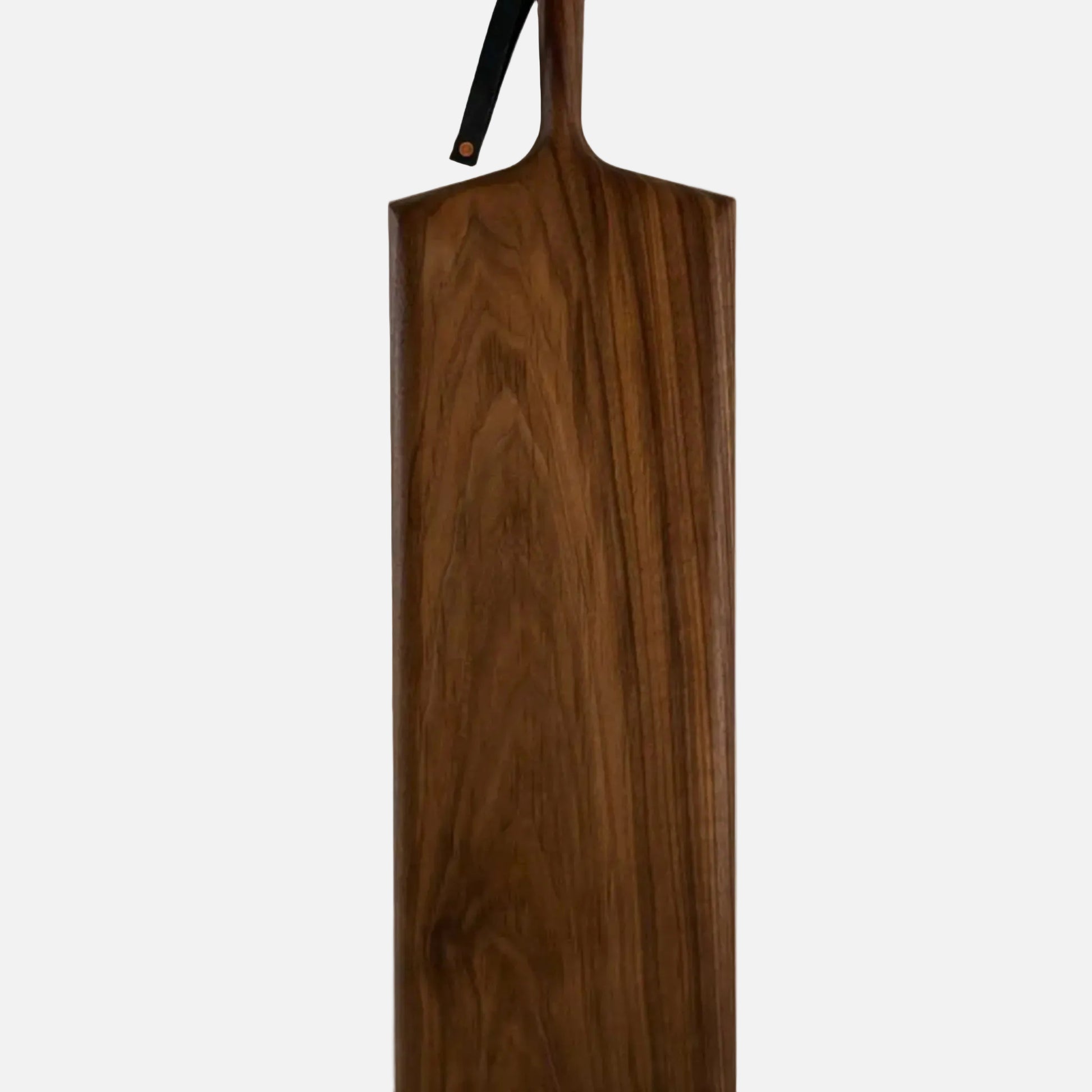 Wooden paddle with a black handle on a white background