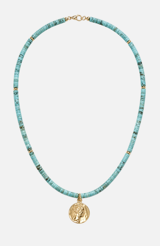 Turquoise beaded necklace with a gold pendant on a white background