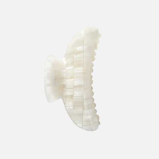 White hair clip on a light gray background