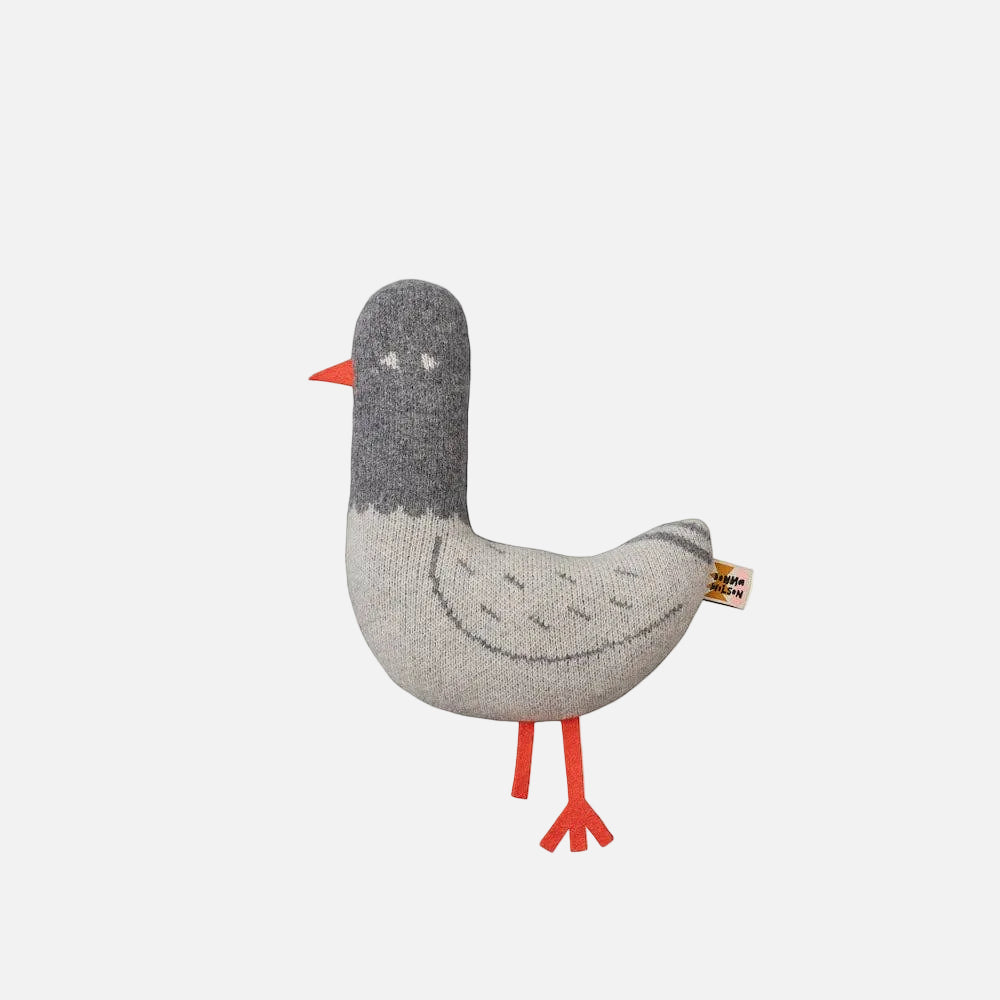 Knitted toy goose with gray body and red legs on a white background