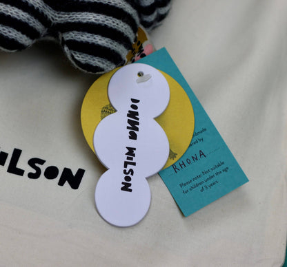 Children's shoe with a branded tag on a light background