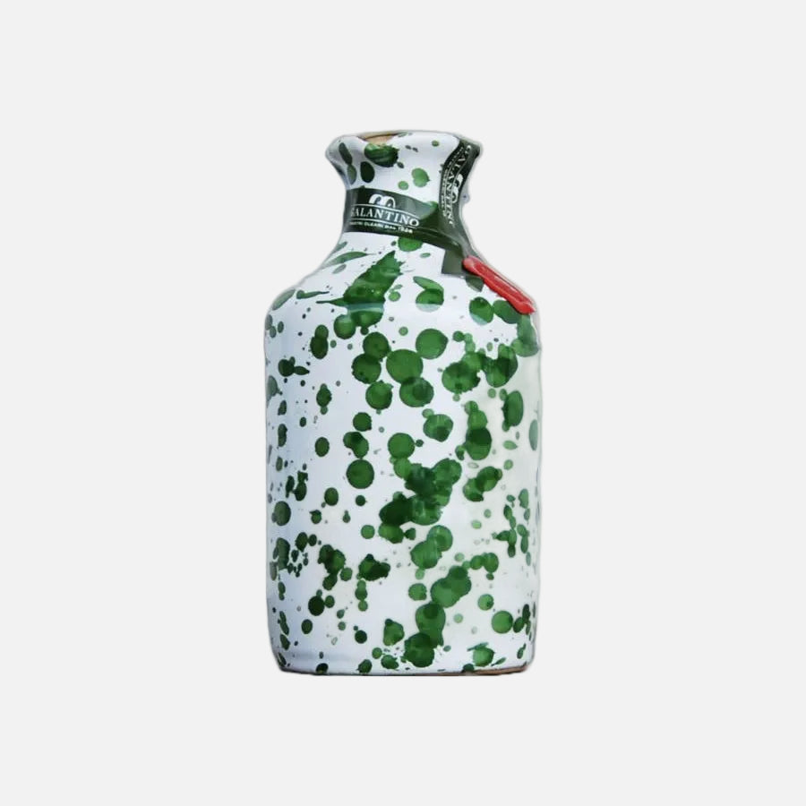 Decorative bottle with green speckles on a white background