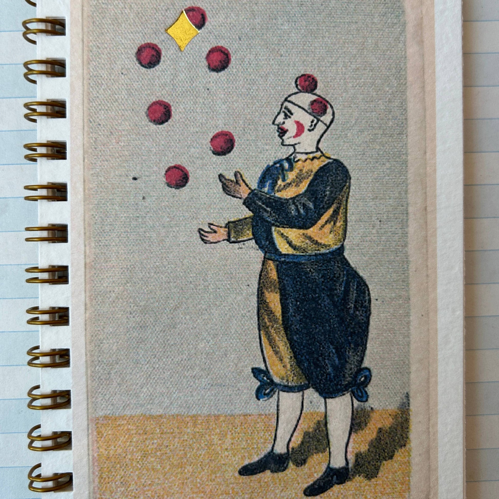 Notebook with a vintage illustration of a clown juggling on the cover.