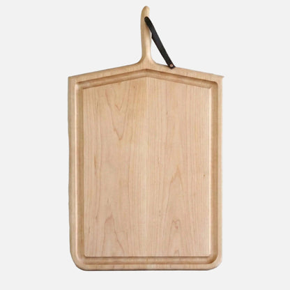Wooden cutting board with a handle on a light gray background