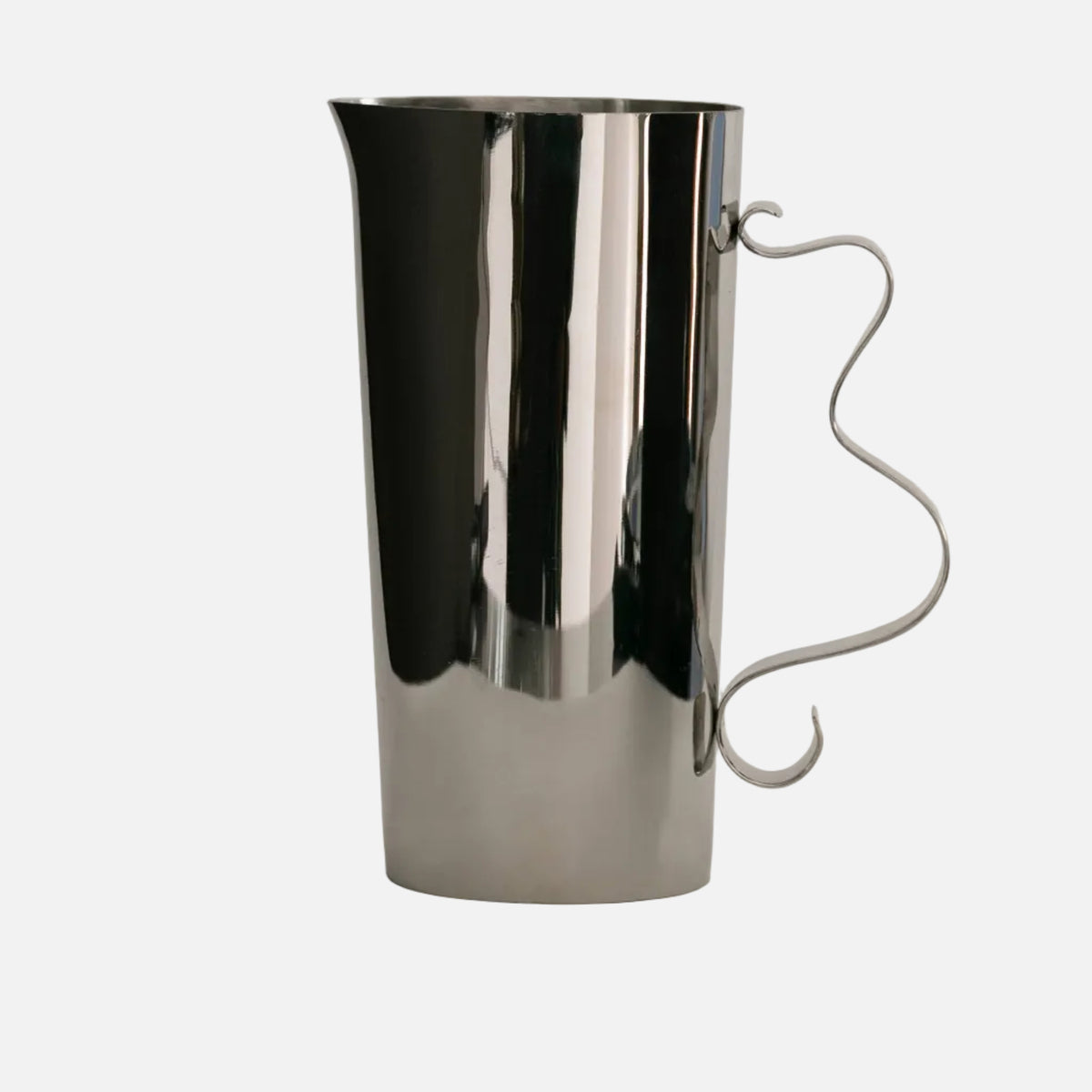 Silver pitcher on a light gray background